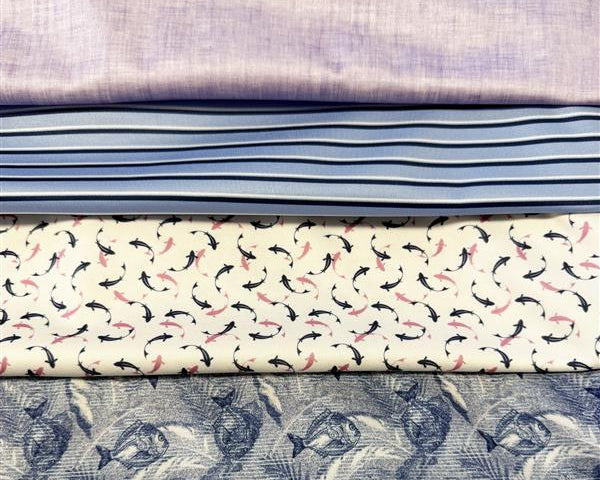 Stack of fabric swatches with various patterns and colors